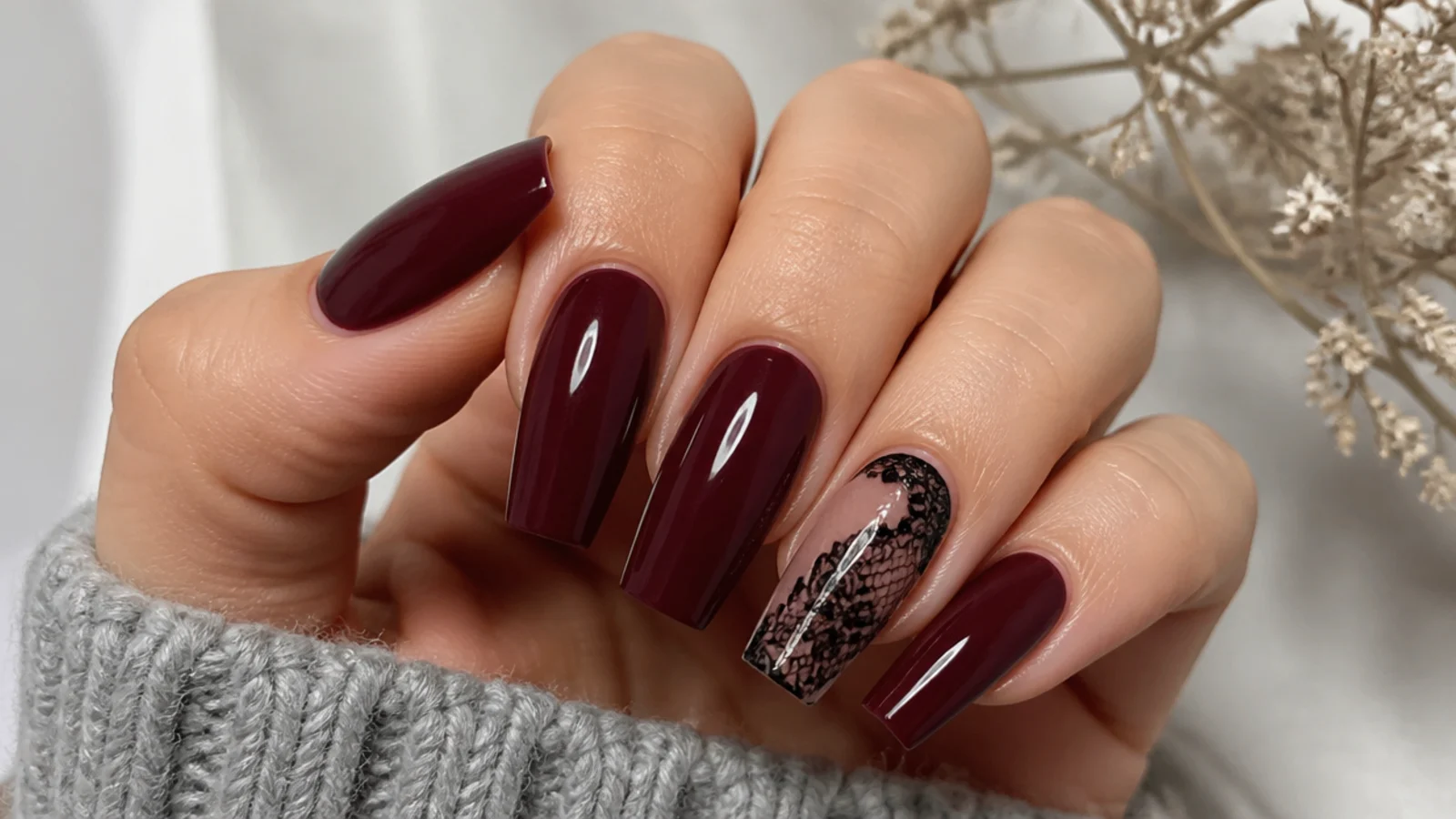 Deep wine coffin nails with fine black lace pattern on an accent nail