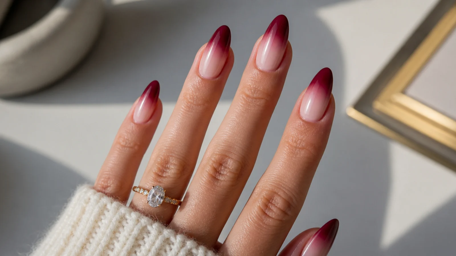 Almond nails fading from sheer nude to deep berry at the tips