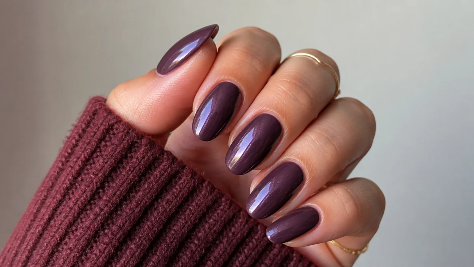 Almond nails in a deep plum with a pearly glazed sheer topper