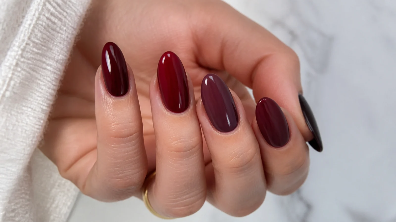 Almond nails each a different deep berry, wine and oxblood shade