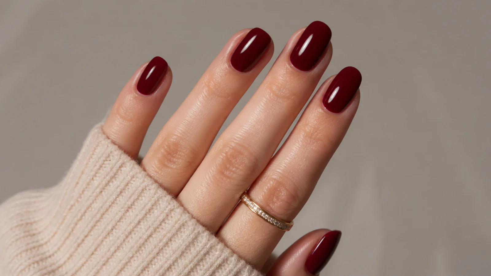 A well-sealed glossy oxblood manicure with cuticle oil for longevity