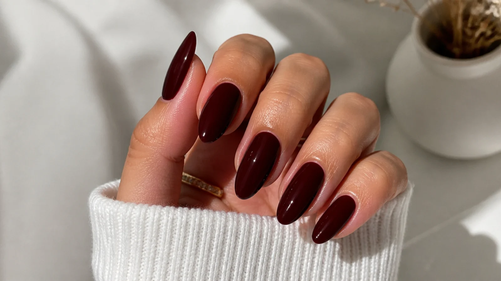 Almond nails in a deep glossy chocolate cherry brown-red