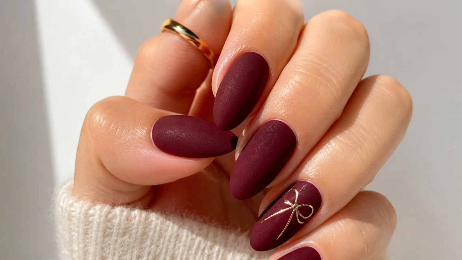 Almond nails in deep oxblood with a soft velvet matte finish