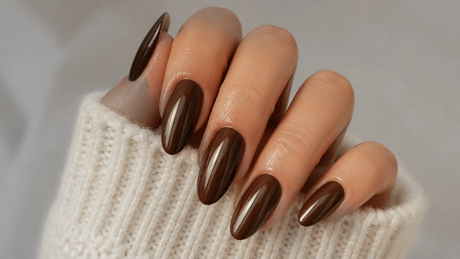 Almond nails in deep espresso brown with a soft warm chrome sheen