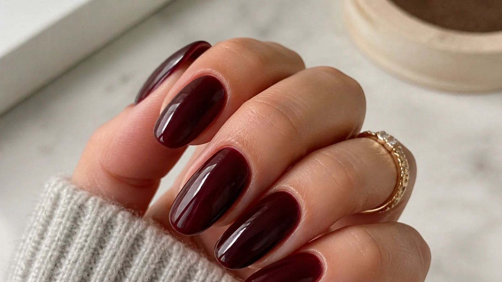 A glossy well-sealed deep berry gel manicure with cuticle oil for longevity