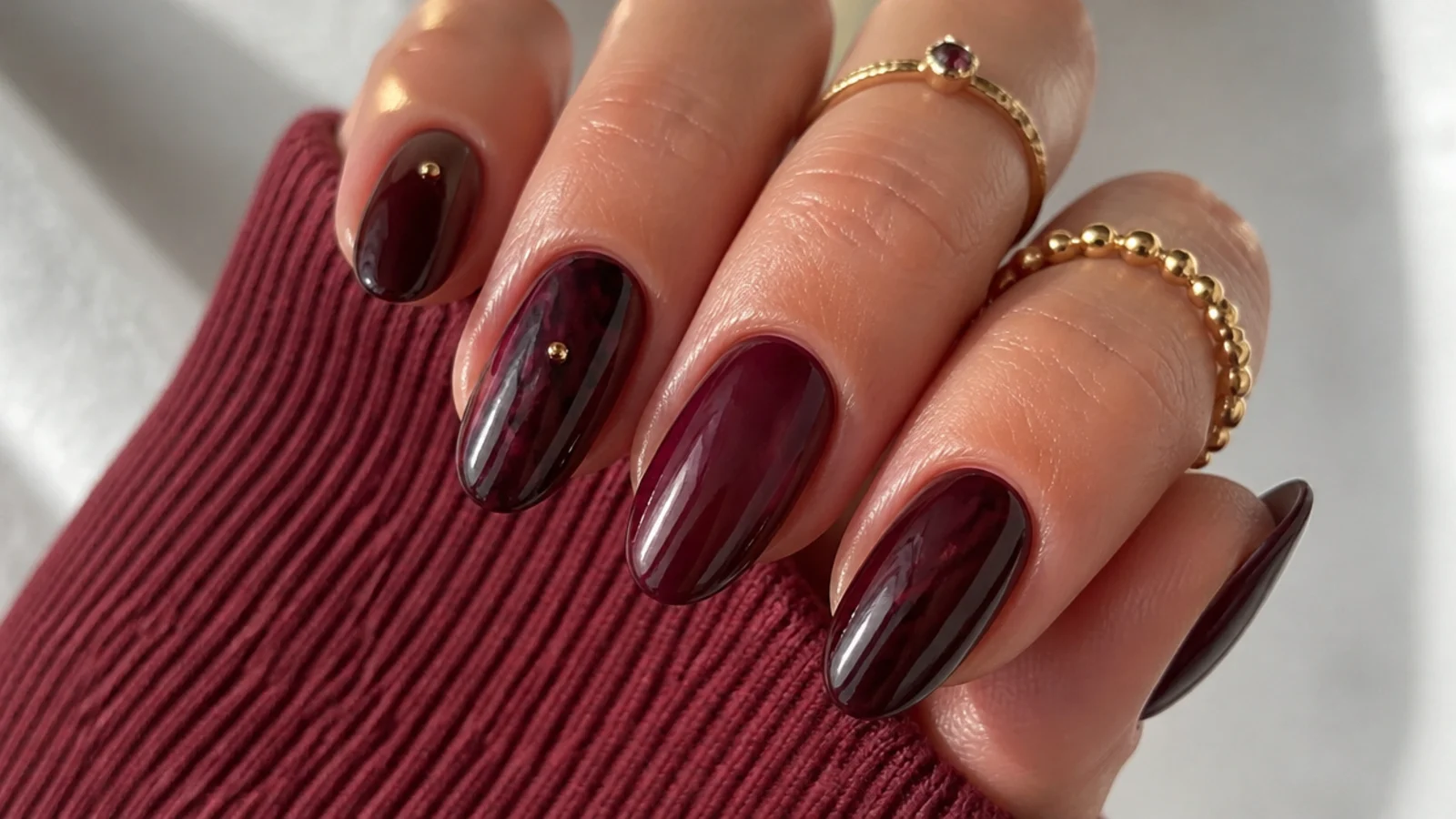 Nails in warm oxblood, berry and wine showing the sultry dark feminine aesthetic