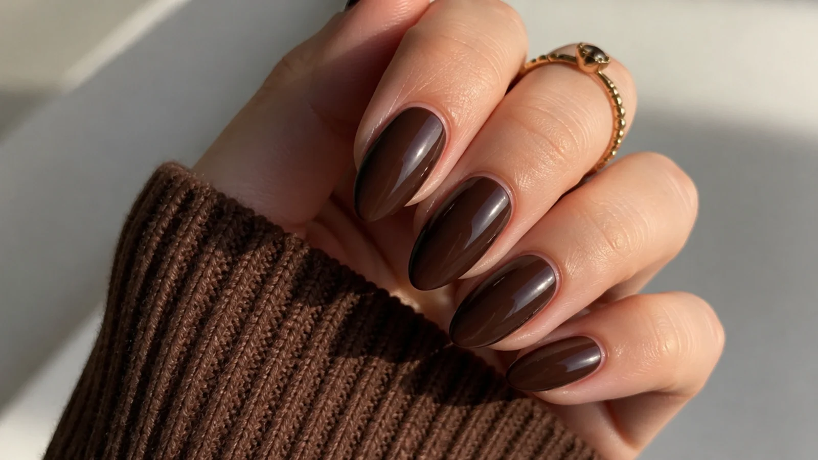 Rich chocolate brown almond nails with a soft glazed shine