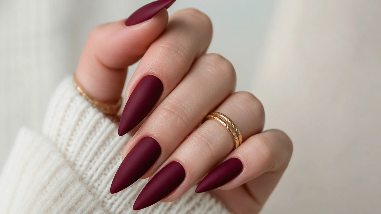 Deep bordeaux stiletto nails with a soft velvet matte finish