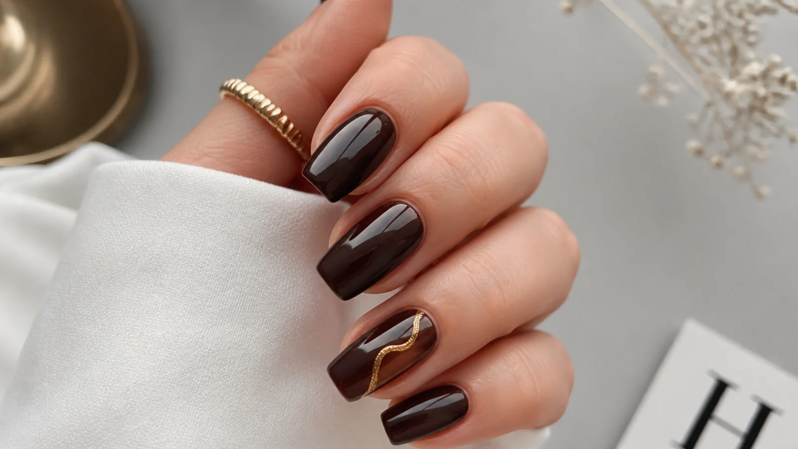 Deep chocolate glossy nails styled for office and evening wear