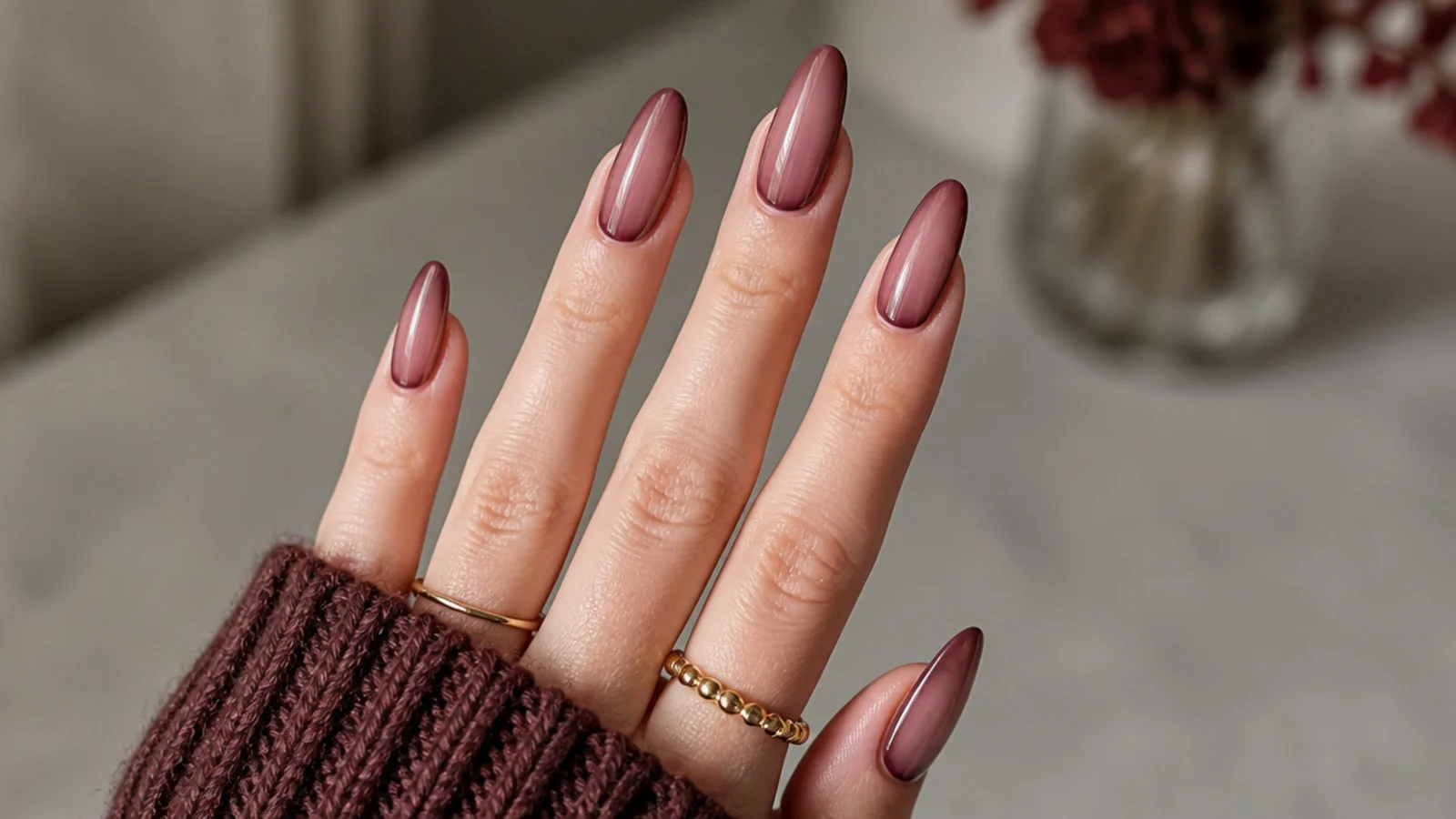 Sheer wine-tinted almond nails with the natural nail showing through