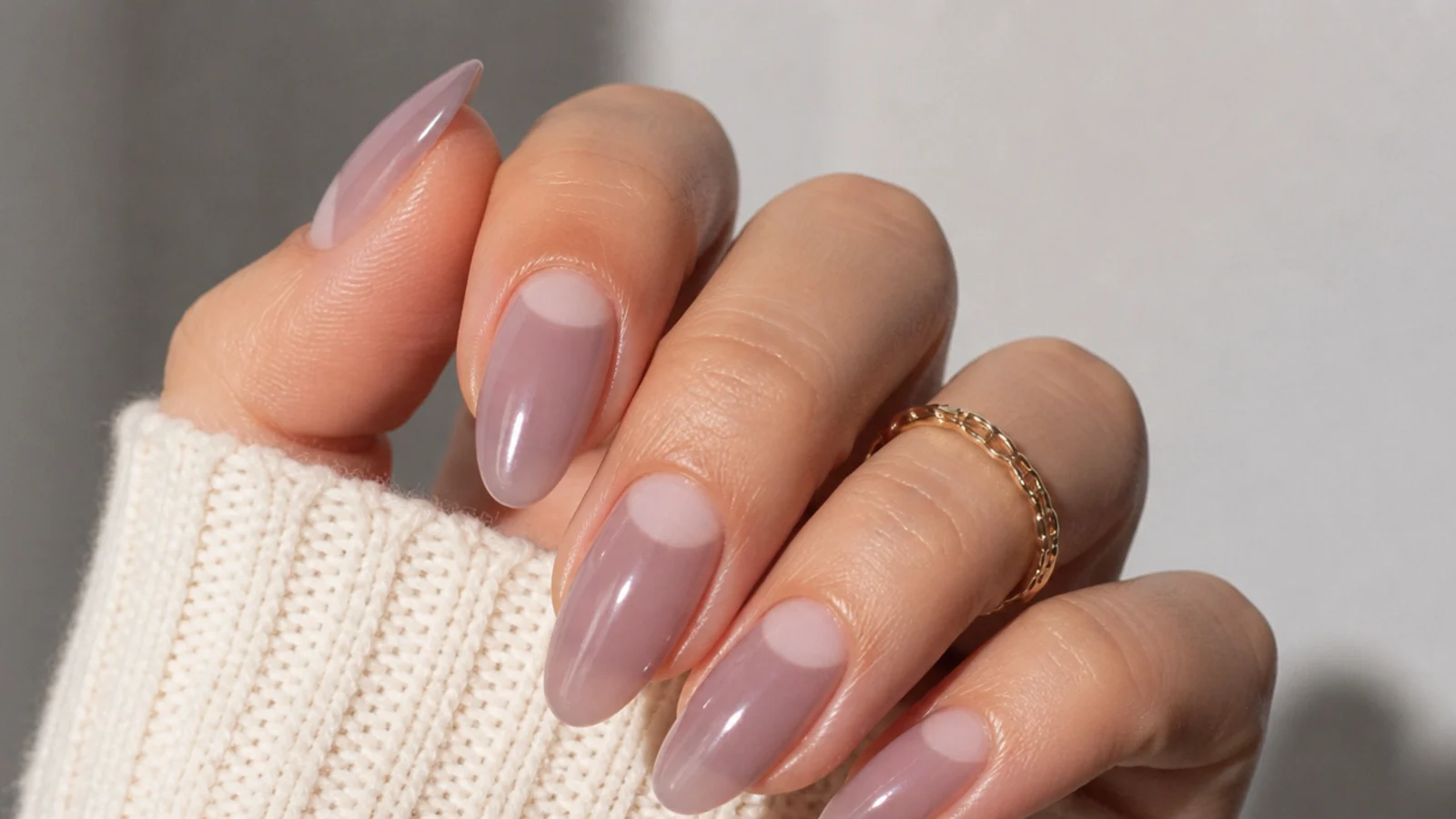 Sheer milky mauve almond nails with soft negative space at the base