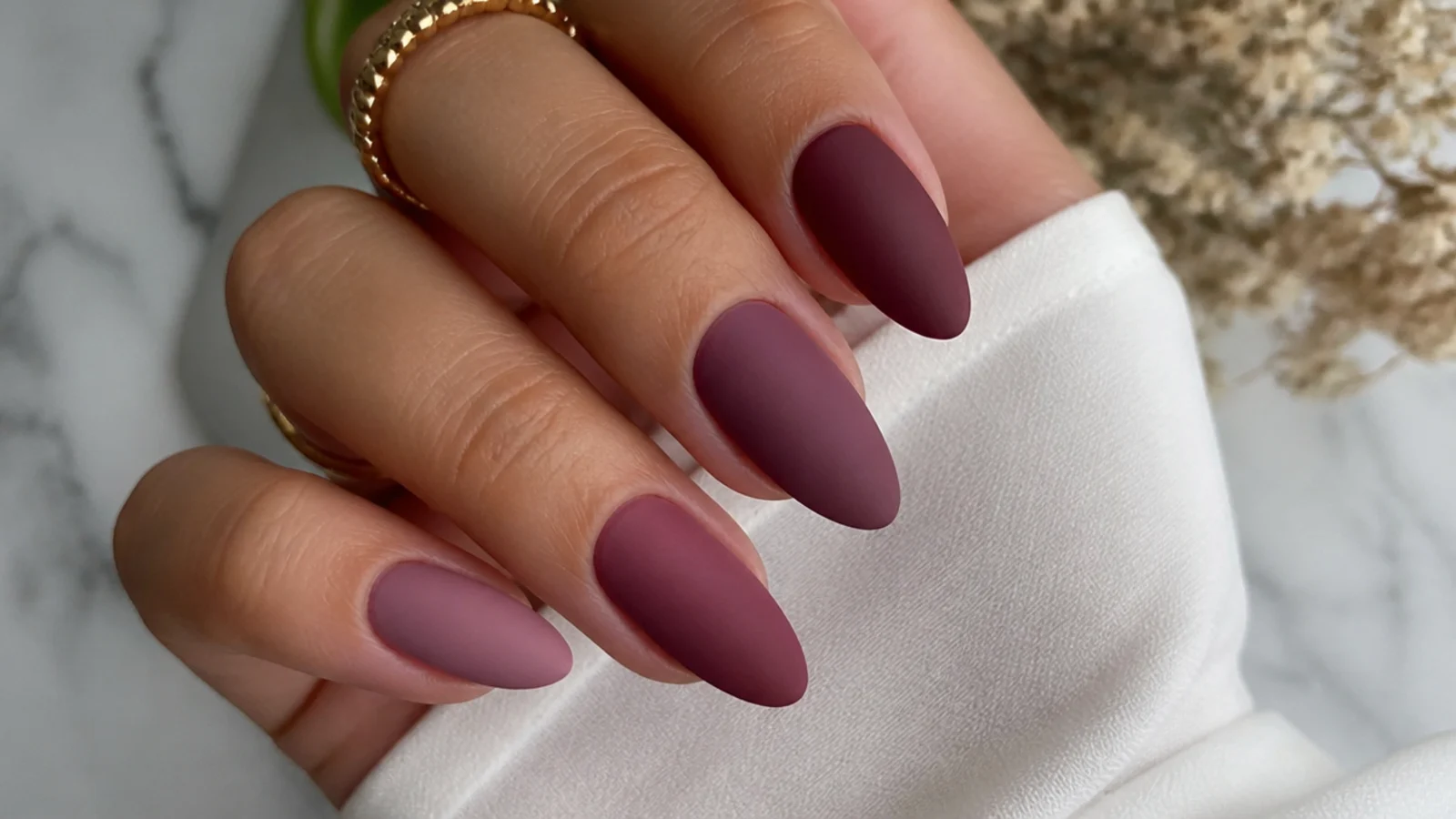 Almond nails fading from soft mauve to deep berry with a velvet matte finish
