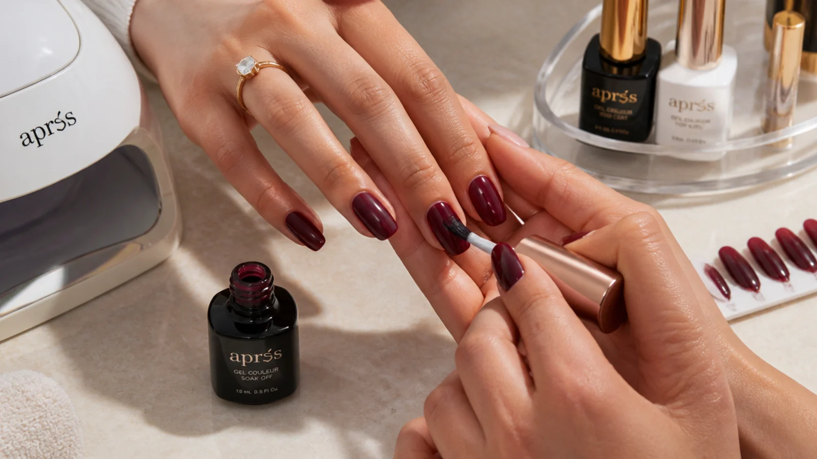 Home gel supplies with a deep oxblood nail mid-application