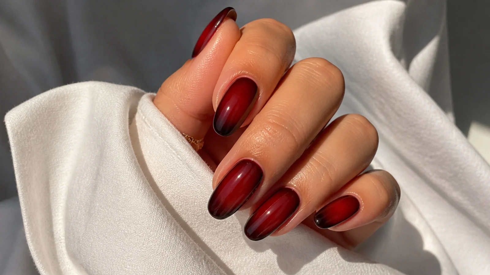 Sheer warm red jelly wash dark feminine nails showing natural nail through color