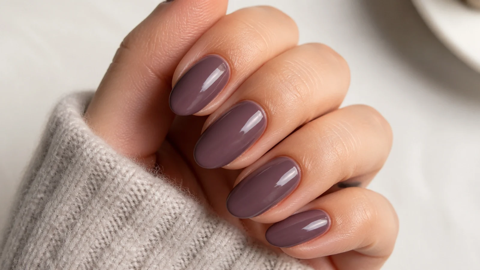 Dusty moody mauve dark feminine nails with a soft glossy finish
