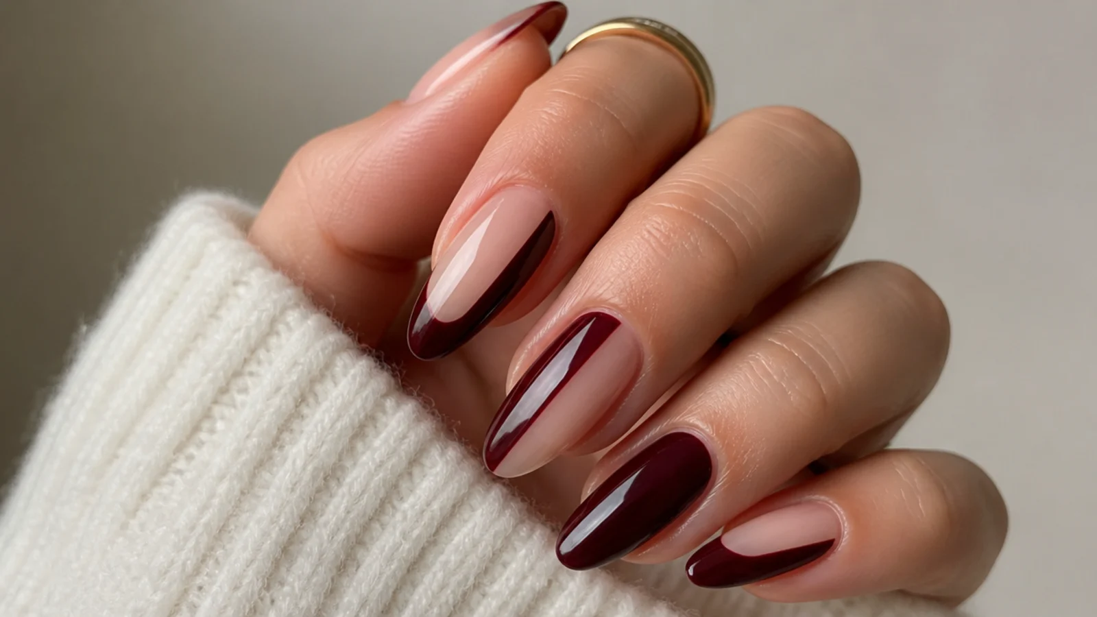 Negative space oxblood dark feminine nails with bare nail and deep red panels