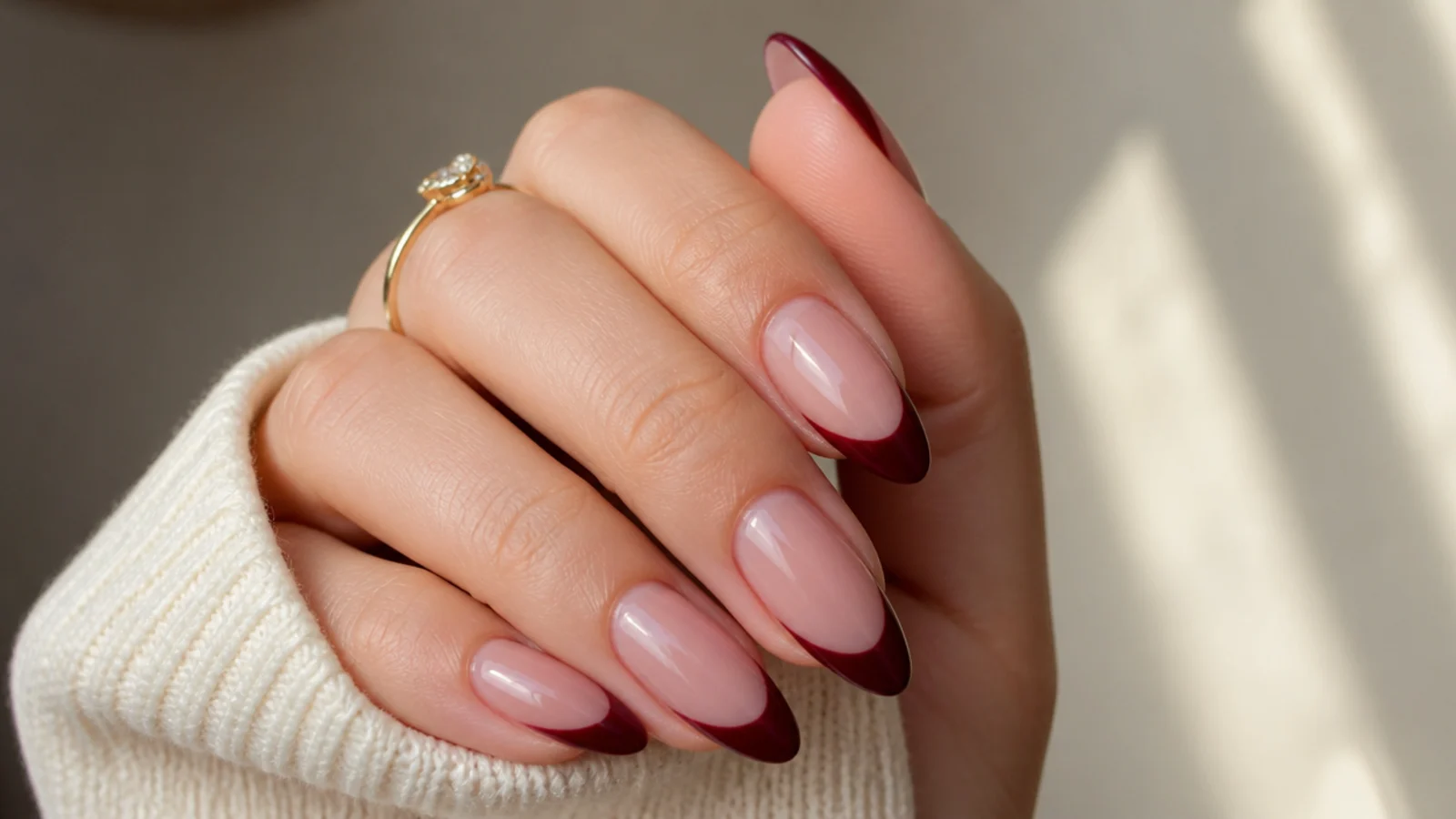Deep cabernet red French tip dark feminine nails on almond nails