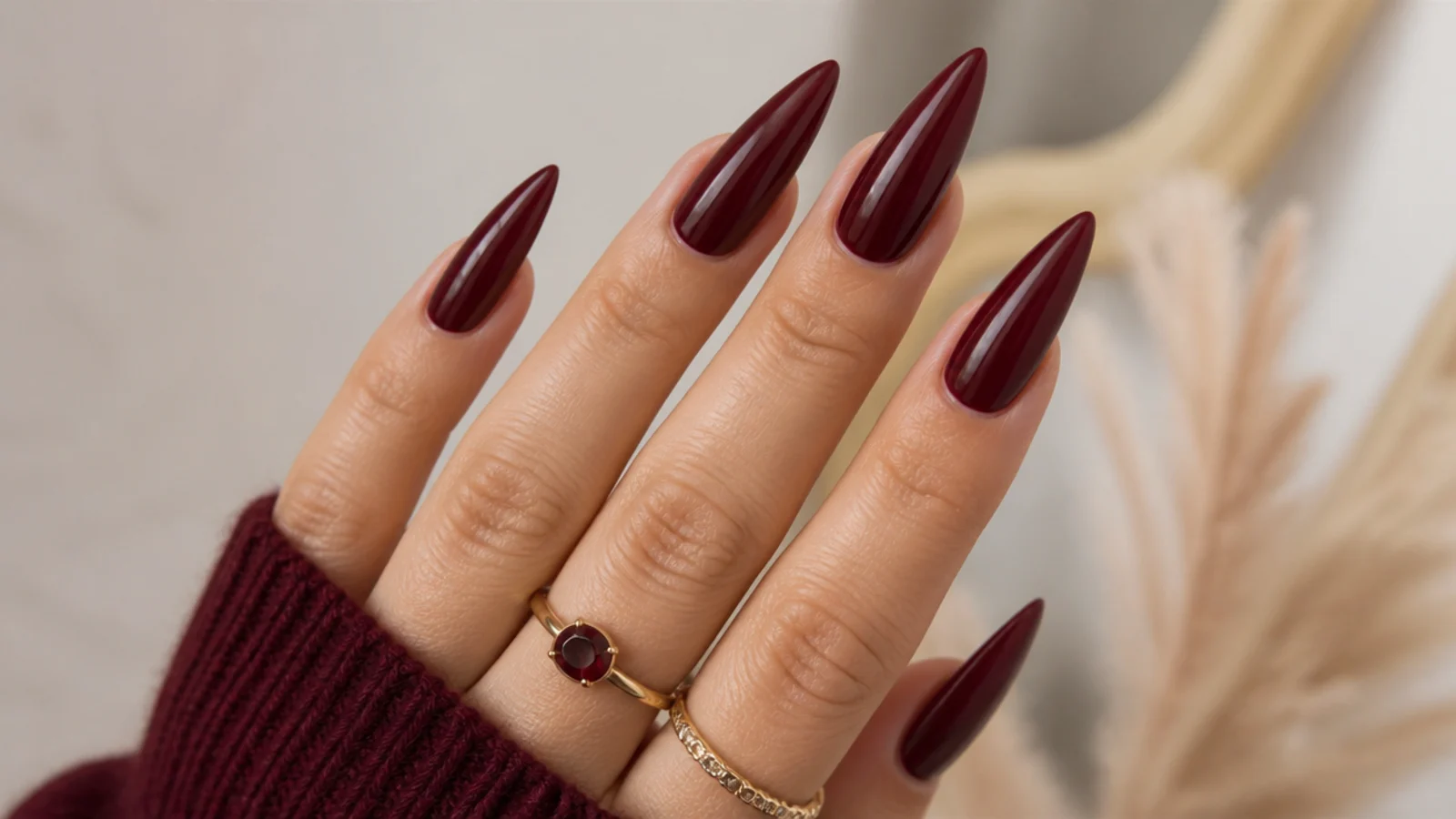 Long oxblood glossy stiletto dark feminine nails with sharp pointed tips