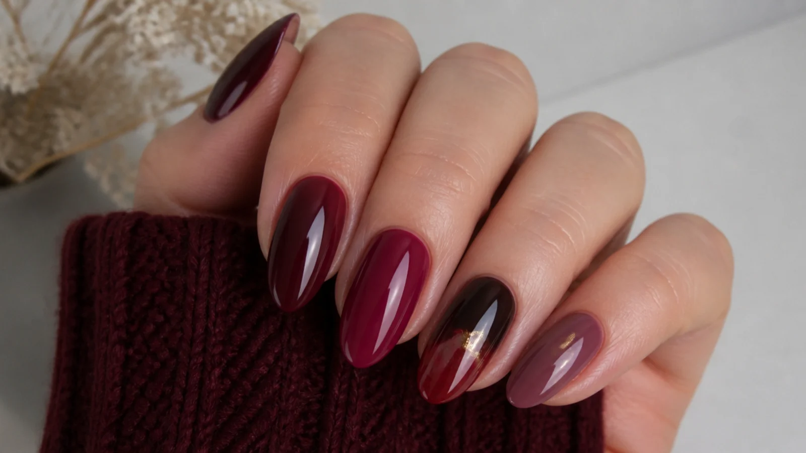Swatches of oxblood, berry, wine, chocolate, sheer red and mauve dark feminine nail colors