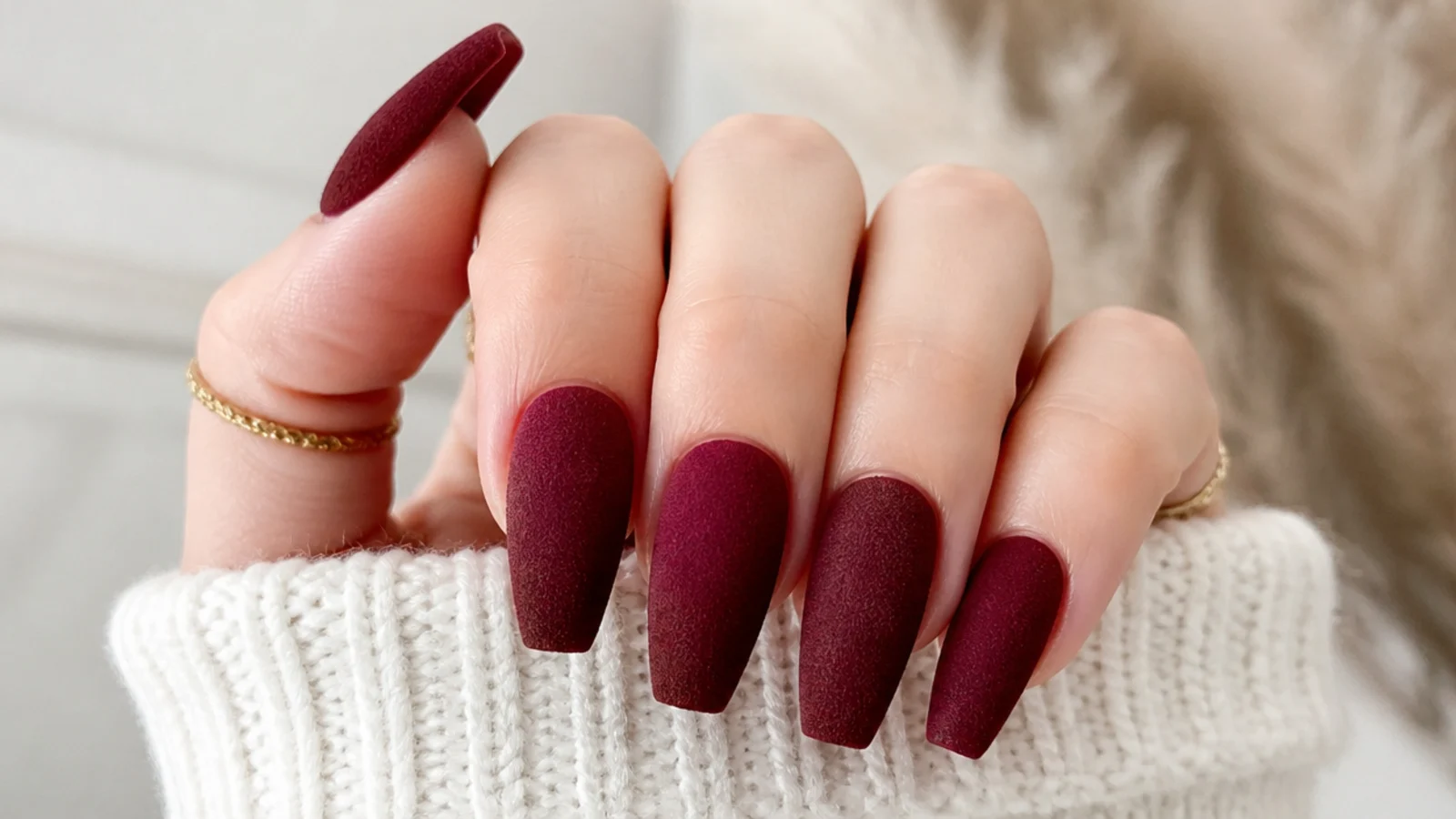 Matte velvet burgundy nails with a soft suede-like finish on coffin tips