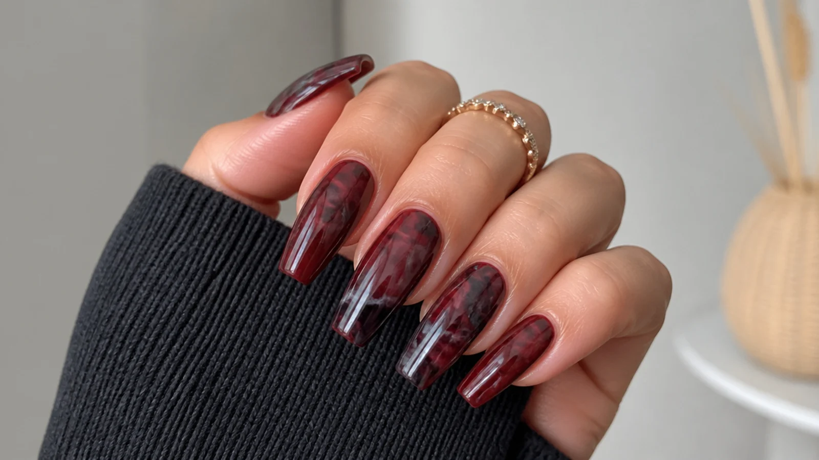 Deep red and black smoky marble nails with soft veining on coffin tips