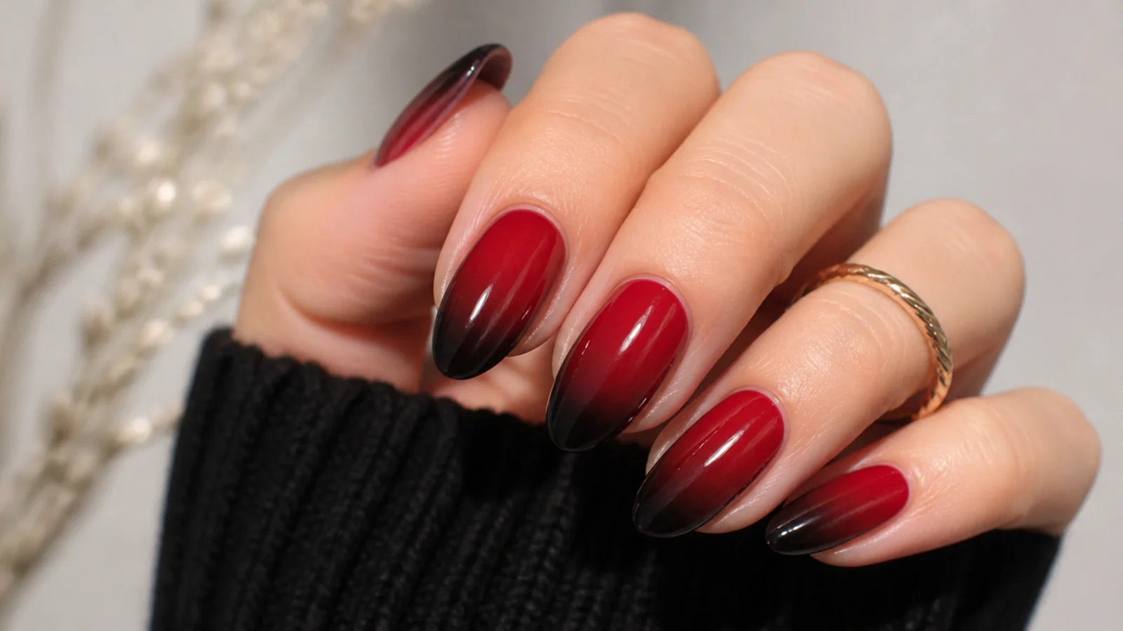 Deep red to black ombre nails fading dark at the tips on almond shape