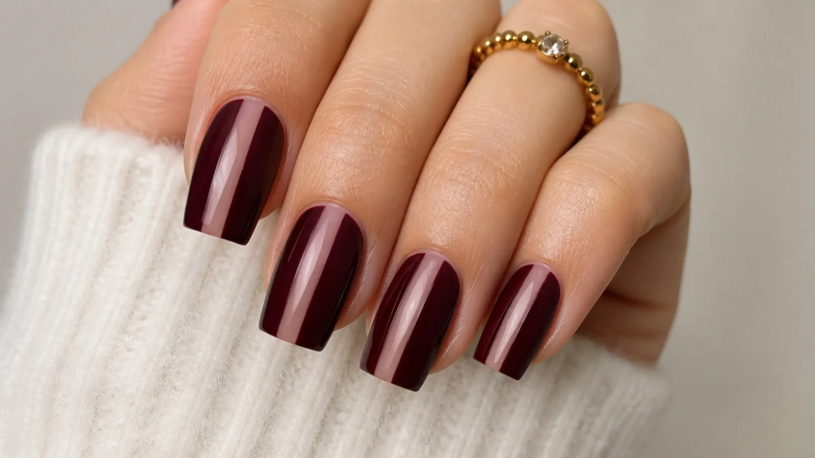 Oxblood square nails with a bare negative space stripe down the center