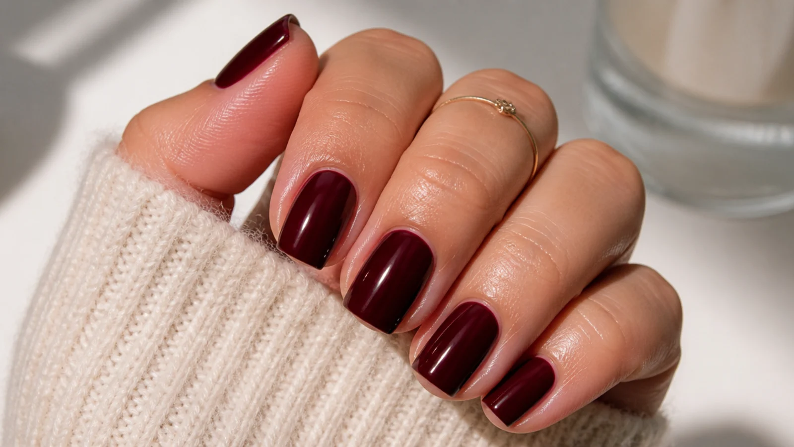 Glossy oxblood dark feminine square nails on a short square shape