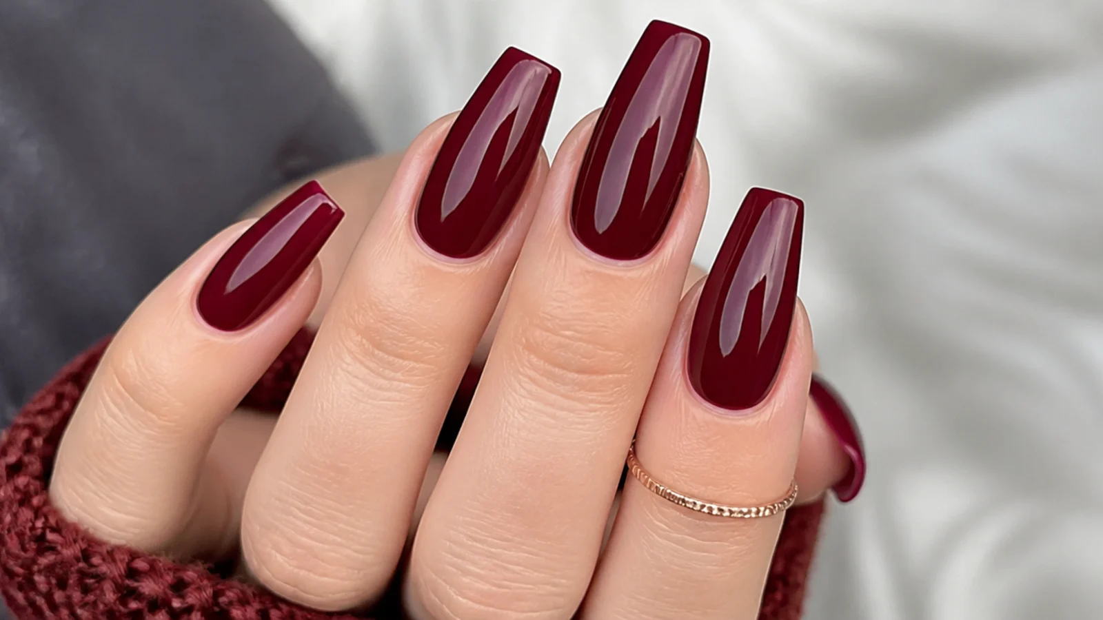 Deep berry wine nails with a glossy glazed finish on coffin shape