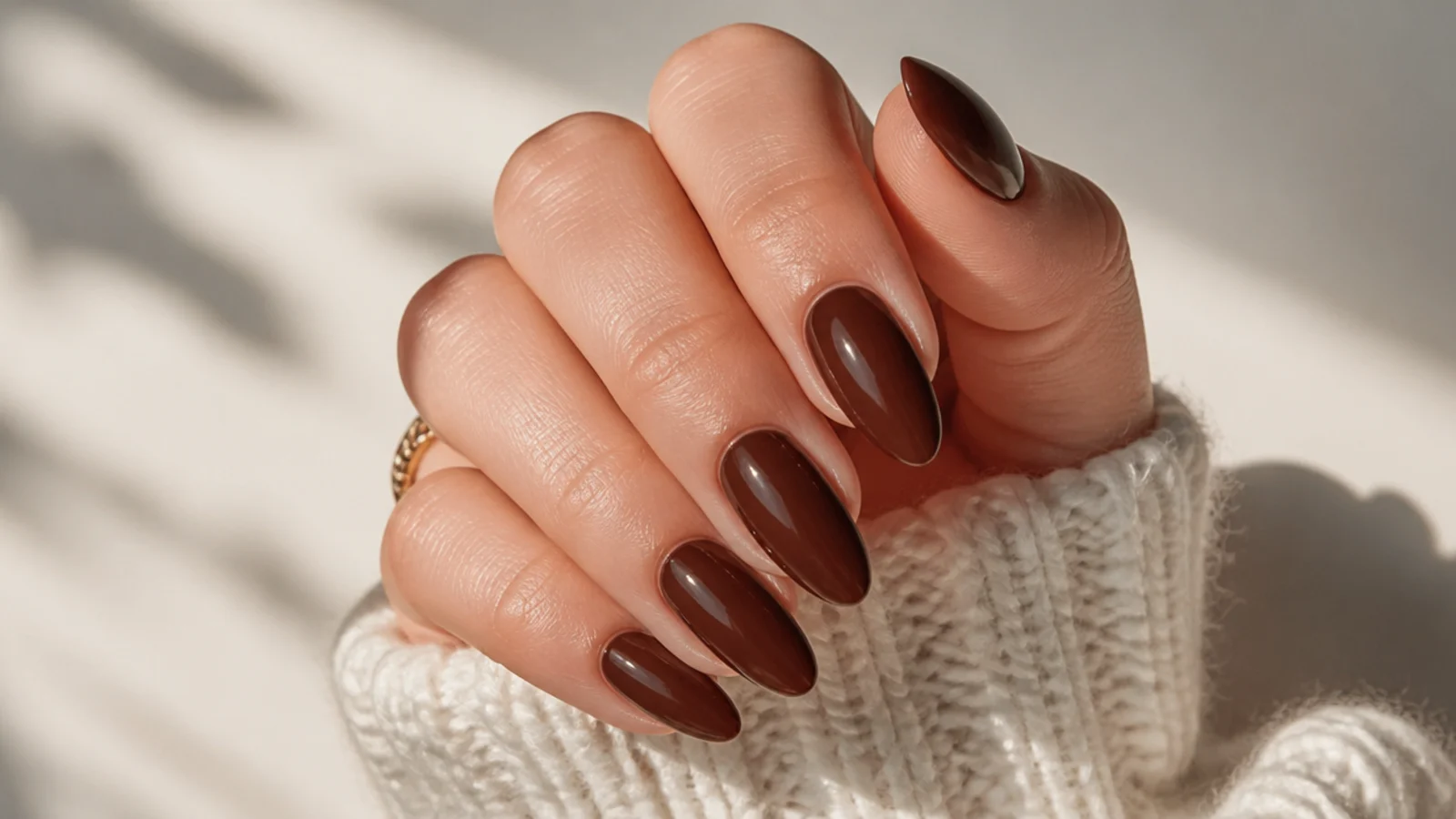 Rich chocolate brown almond nails with a glossy finish