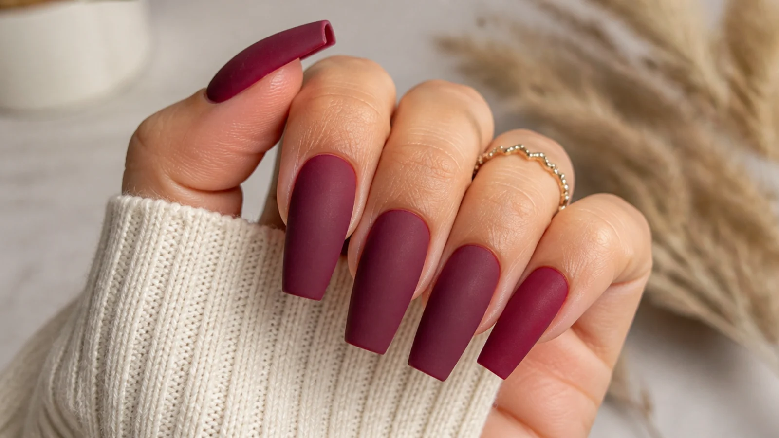 Matte velvet burgundy nails with a soft suede finish on coffin nails