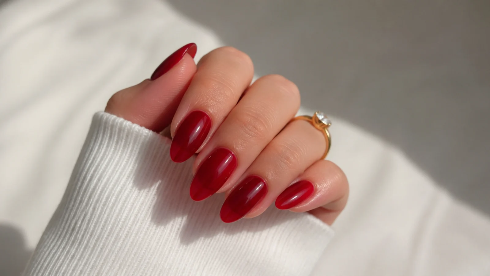 Sheer cherry red jelly nails with a glassy translucent finish