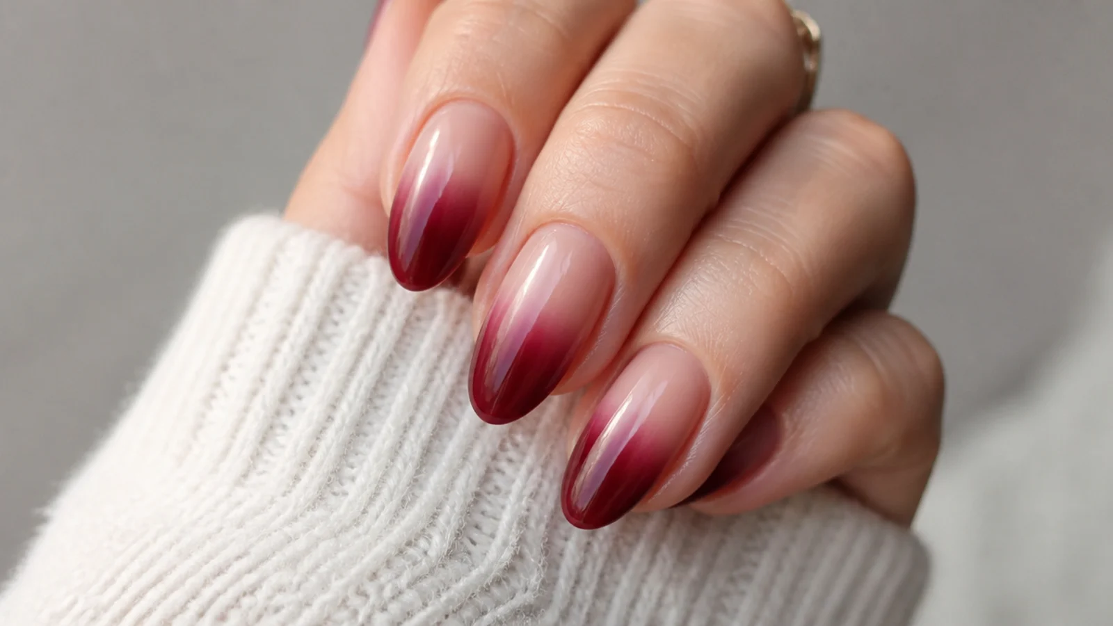 Sheer nude to deep berry ombre nails fading toward the tips