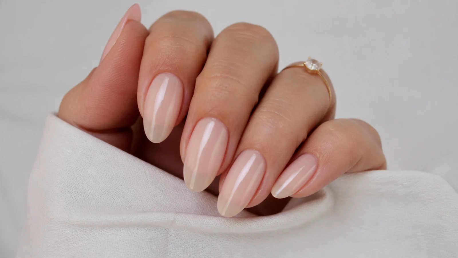 Sheer milky nude almond nails with a soft glazed finish