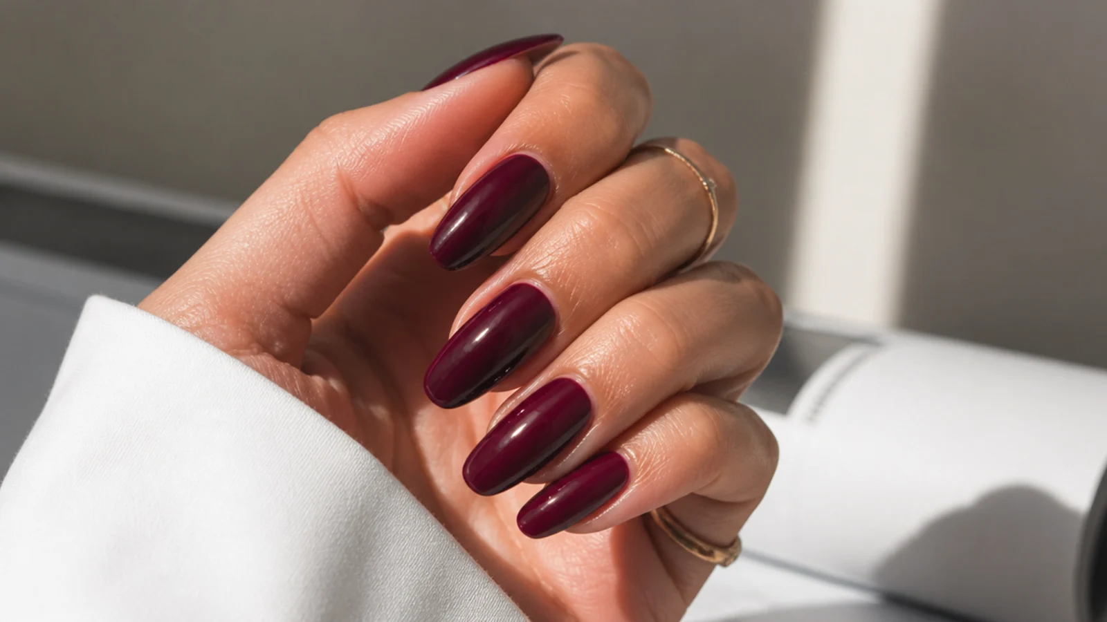 Glossy deep berry almond nails with a rich shine
