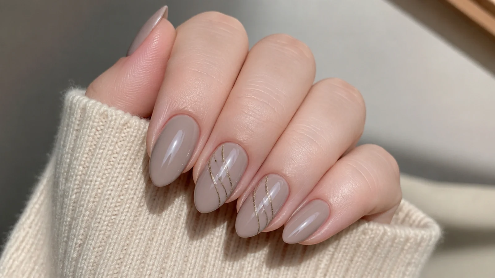 Soft greige clean girl nails on a neutral almond shape
