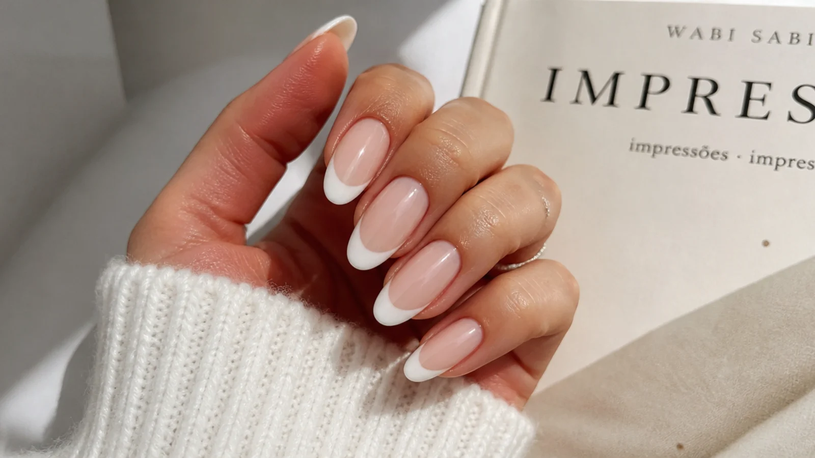 Soft milky French tip clean girl nails on an almond shape