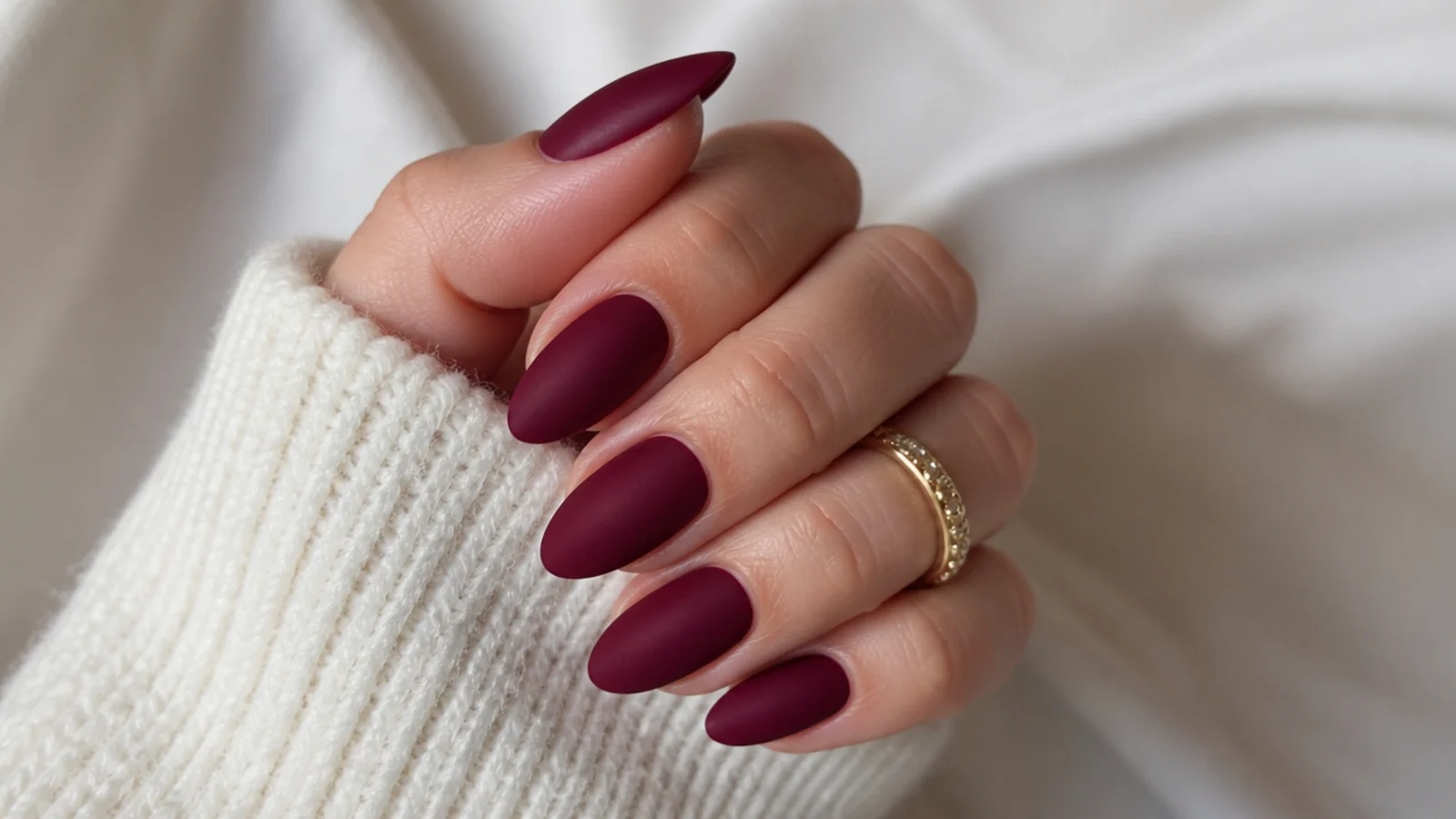 Deep wine matte almond nails with a soft velvet finish