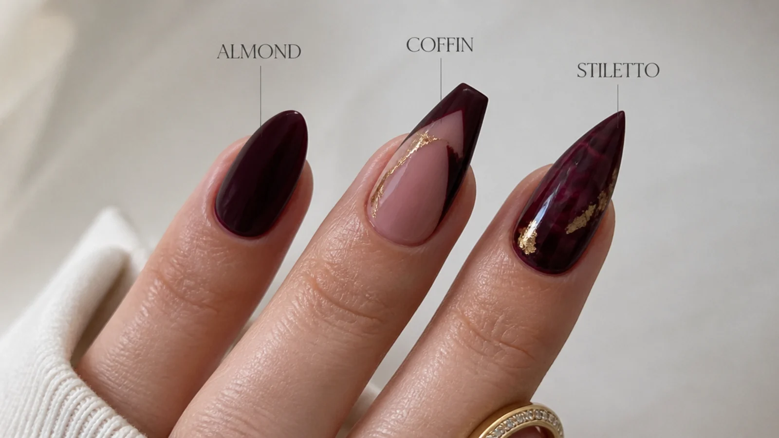 Almond, coffin and stiletto dark feminine nails shown side by side