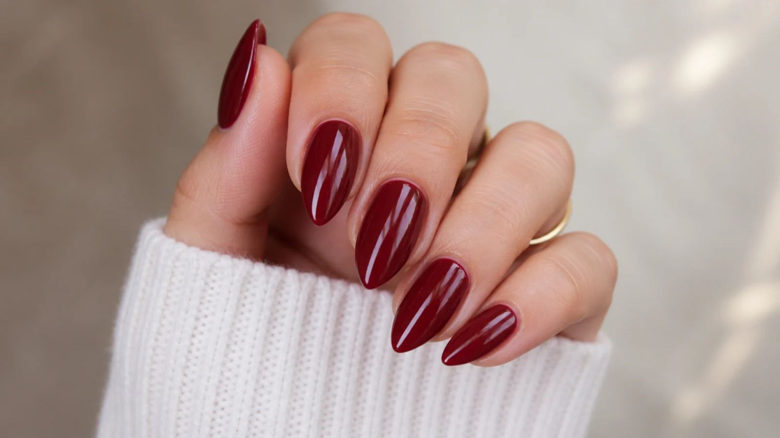 Short stiletto nails in glossy deep vampy red