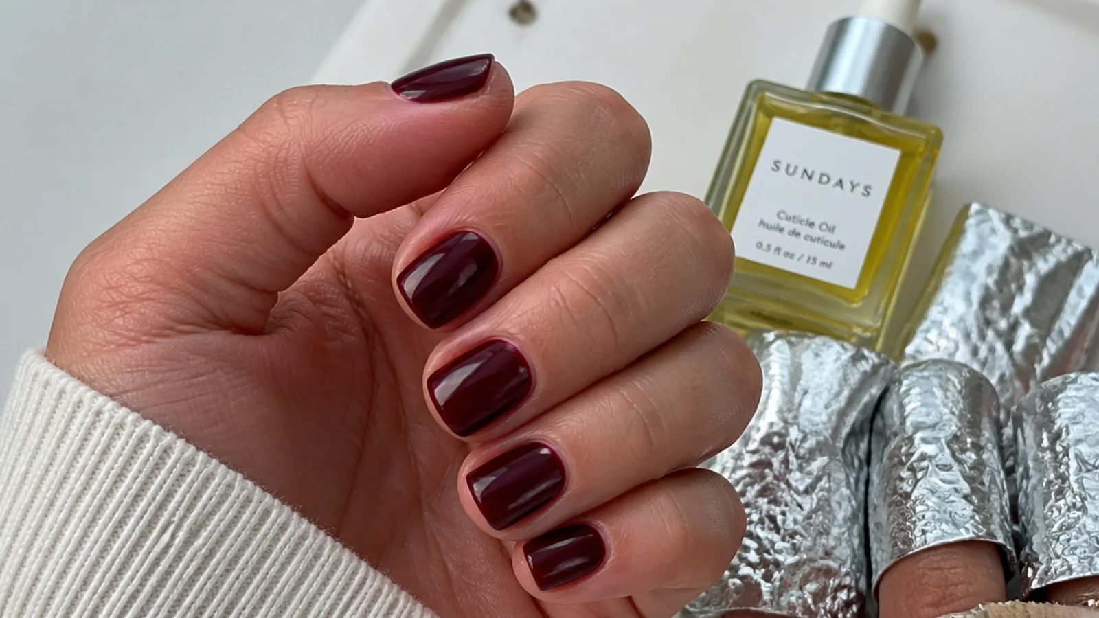 A short oxblood gel manicure with cuticle oil and acetone foils