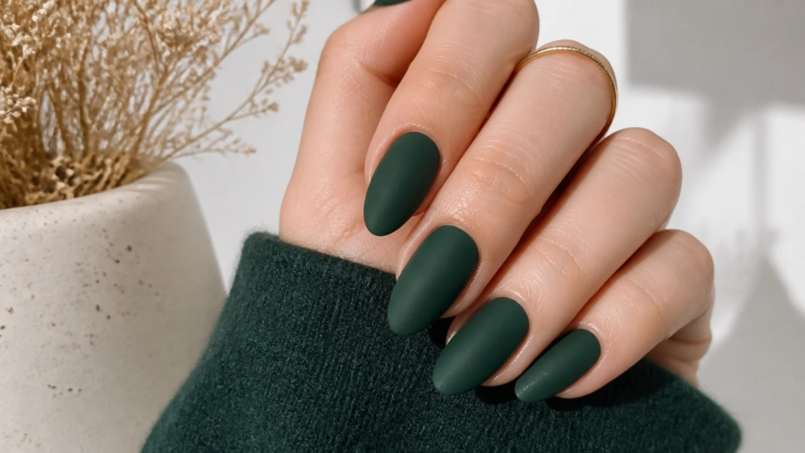 Soft matte dark emerald green nails with a velvet finish