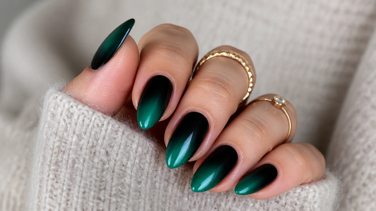 Dark emerald green nails fading into black at the base