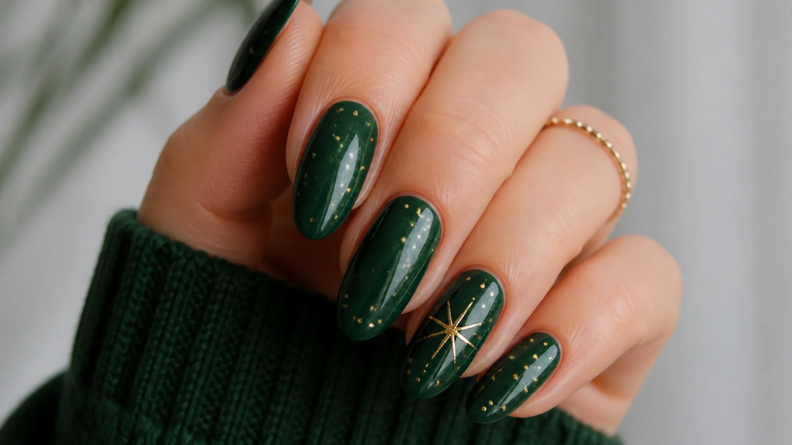 Dark emerald green Christmas nails with gold dots and a star accent