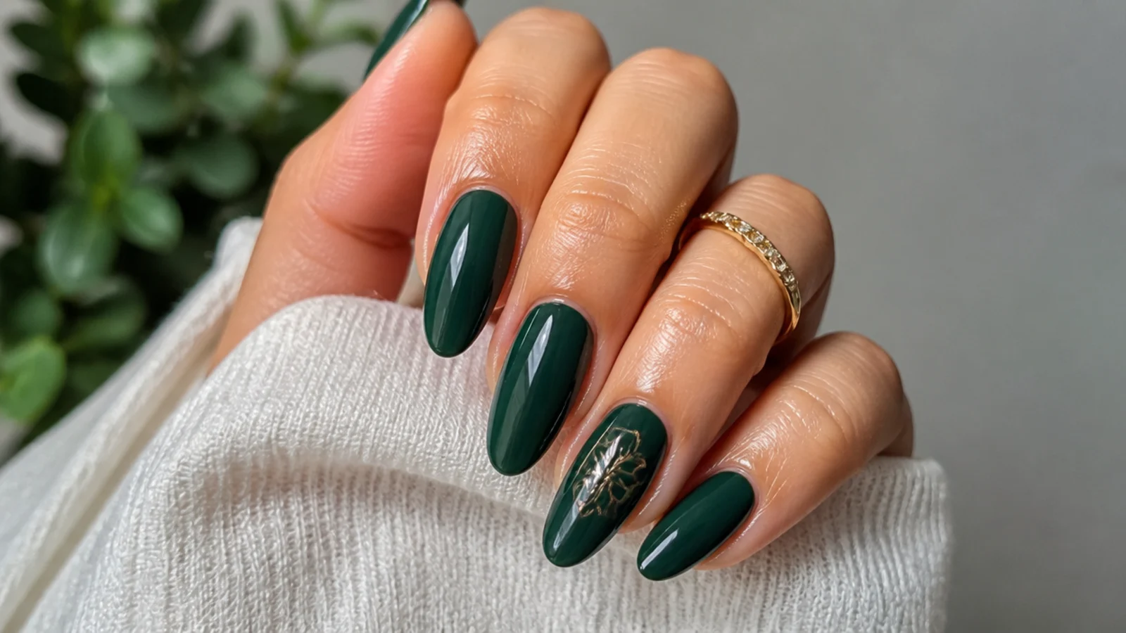 A sealed glossy dark emerald manicure with cuticle oil for longevity