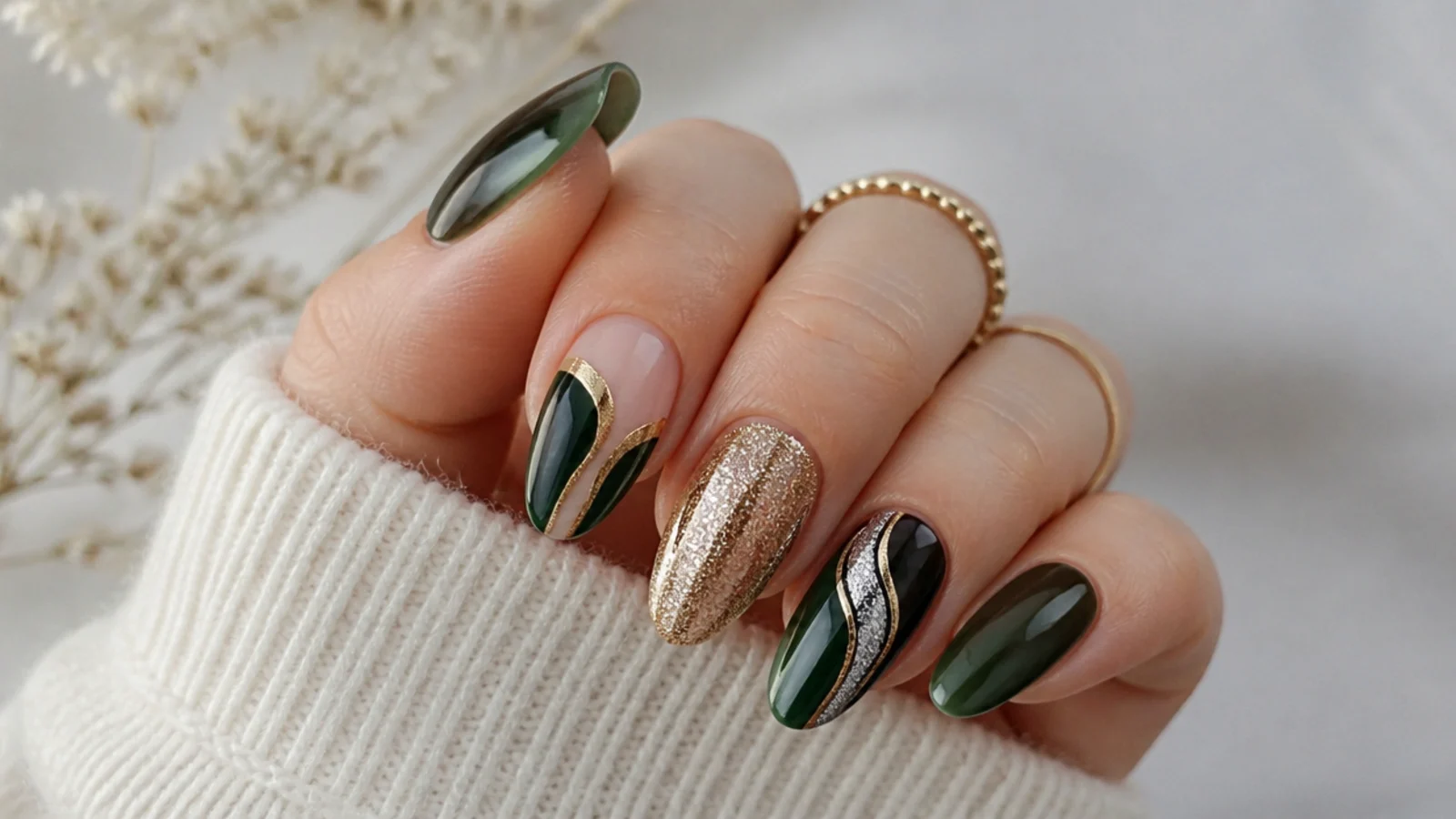 Dark emerald green nails shown with gold, silver, black and nude accents