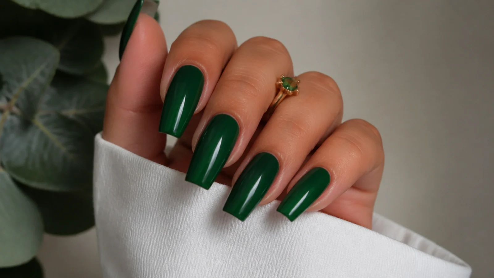 Rich glossy emerald green nails on a coffin shape