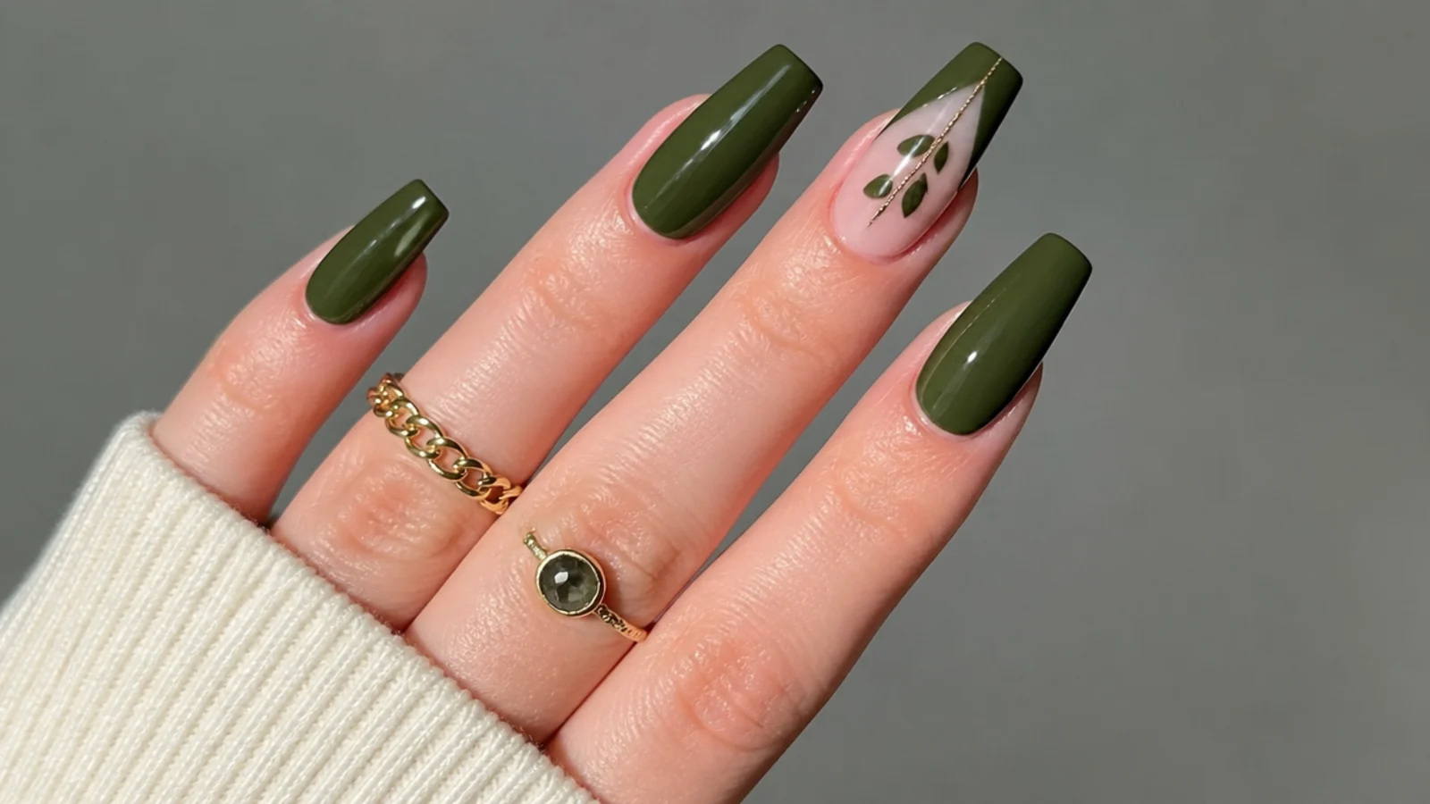 Deep muted forest green acrylic nails on a long coffin shape