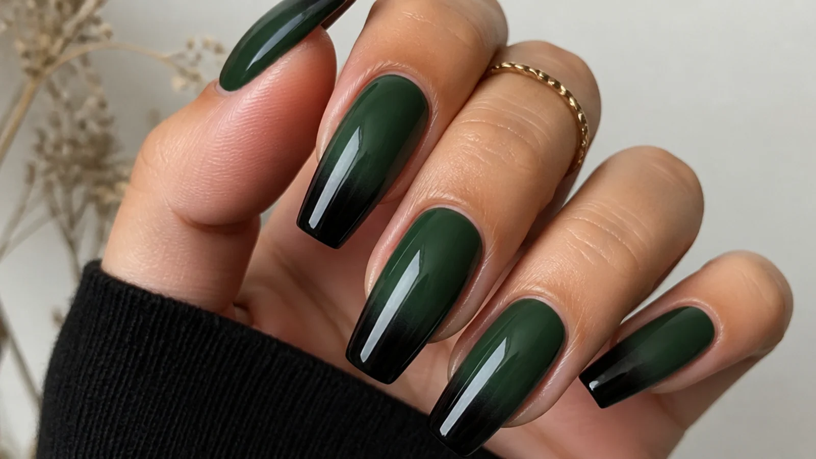 Dark green fading to black ombre acrylic nails on a coffin shape