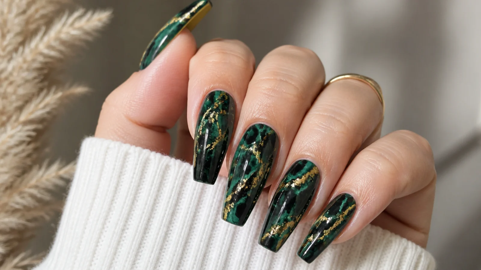 Emerald green and black swirl acrylic nails on a coffin shape